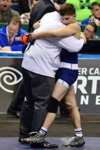 Matteo DeVincenzo hugs head coach Mike Maletta after earning his second New York State championship crown. Photo by Luci DeVincenzo