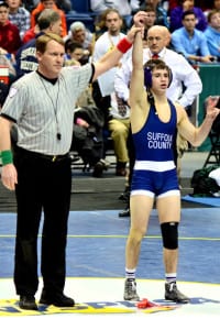 Matteo DeVincenzo has his arm raised by the referee after winning his New York State championship finals matchup. Photo by Luci DeVincenzo