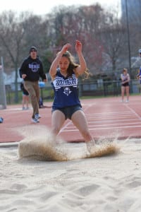 Anna Gulizio leaps into the sand. File photo from Huntington Athletics