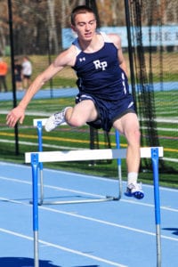 Cameron Cutler leaps over the hurdles for Rocky Point. Photo by Bill Landon