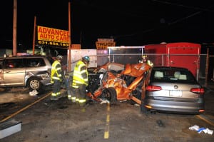 The driver of aDodge Neon was trapped between two cars on Sunday night. Photo by Steve Silverman