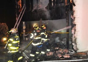 Fire fighters work to put out the flames of a Lloyd Harbor house fire. Photo from Steve Silverman