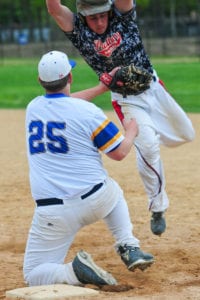 Comsewogue's Jordan Lisco makes the tag against a Miller Place player at first base. Photo by Bill Landon