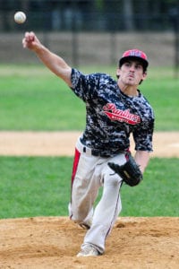 Thomas Bell hurls a pitch from the mound for Miller Place. Photo by Bill Landon