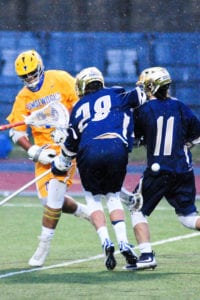 Richie Lacalandra snaps a shot between two Bayport-Blue Point defenders for the score. Photo by Bill Landon