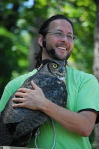 Eric Powers holds a great horned owl. Photo from Carole Paquette 