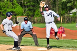 First baseman Dan Heller attempts a pickoff. Photo by Bill Landon
