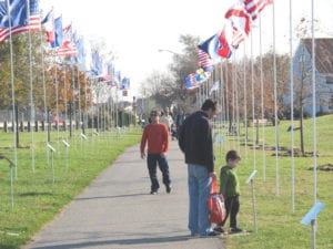 Visitors enjoy the annual Parade of Flags at Heritage Park in Mount Sinai. Photo from Fred Drewes