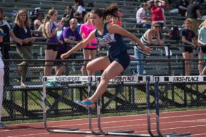 Alexandra Koumas leaps over the hurdle at a previous meet. Photo by Darin Reed 