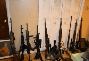 Ten assault rifles, a hand gun, high capacity magazines, a shotgun and a stun gun were retrieved from a home in Mount Sinia. Photo from SCPD