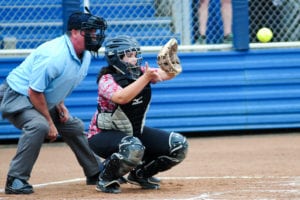 Sabrina Burrus reaches out to grab the ball behind the plate. Photo by Bill Landon