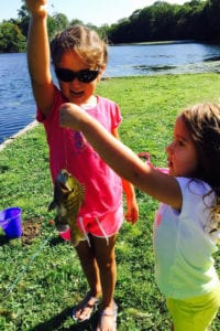 From left, Sofia and Angelina Pace of Smithtown with a bluegill they caught last summer at Willow Pond. Photo from Paul Pace