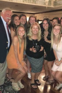 Members of the Smithtown West girls' lacrosse team rally around head coach Carrie Bodo after she earned the Suffolk County Coach of the Year award. Photo from Smithtown school district