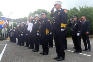 The Wading River Fire Department honors Thomas Lateulere during mass, outside St. John the Baptist R. C. Church in Wading River on July 1. Photo by Wenhao Ma