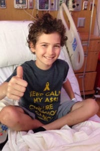 Thomas gives a thumbs-up in his fight against childhood cancer T-shirt. Photo from Despina Scully
