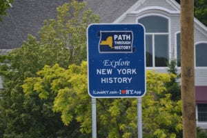 Blue road signs promoting the I Love NY campaign sprung up in Port Jeff on Route 25A this month, but will be replaced with smaller ones following community outrage. Photo by Alex Petroski