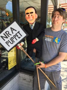 A member of Gays Against Guns holds up a puppet of U. S. Rep. Lee Zeldin during a protest. Photo from Duncan Osborne 