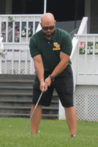 Ward Melville head football coach Chris Boltrek gets in the zone during the golf tournament. Photo by Kevin Redding