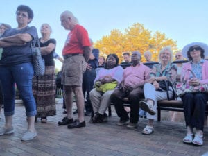 Residents stand outside village hall listening to the meeting. Photo by Victoria Espinoza