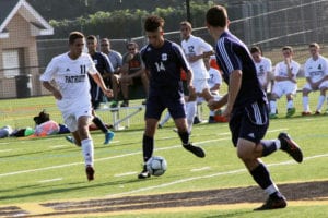 Brandon Erny maintains control of the ball in a game against Ward Melville last season. File photo by Desirée Keegan