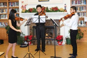 From left, Yong Cai, Joshua Cai and Xavier Tutiven perform over the holiday at the Rose Caracappa Senior Center in Mount Sinai. Photo from Yong Cai