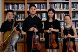 The North Shore Youth Music Ensemble’s, from left, Daniel Ma, Joshua Cai, Claire Cai and Claire Xu performed at the Rose Caracappa Senior Center in Mount Sinai. Photo by Rebecca Anzel 