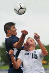 Northport's Justin Carrano and Huntington's Kevin Gulizio leap up to head the ball. Photo by Bill Landon