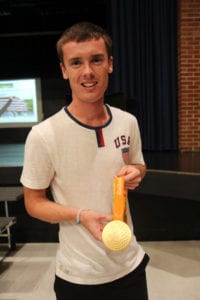 Mike Brannigan smiles and holds his gold medal. Photo by Victoria Espinoza