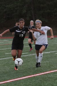 Mount Sinai’s Brooke Cergol and Shoreham-Wading River’s Alex Kuhnle race for the ball. Photo by Desirée Keegan