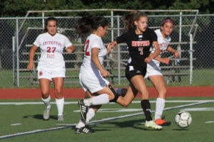 Newfield's Taylor Regensburger leads the race to the ball. Photo by Desirée Keegan