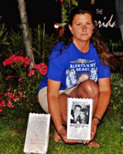 Tracey Budd, a Rocky Point resident and founder of North Shore Drug Awareness Advocates, displays her luminaire in memory of her son Kevin during the third annual Lights of Hope event in Port Jefferson on Aug. 31. Photo by Nora Milligan 