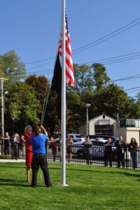 Brookhaven Town Councilwoman Jane Bonner helps members of Rocky Point VFW Post 6249 in the flag raising ceremony Oct. 17. Photo by Desirée Keegan