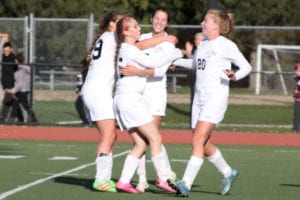 Antonia Calamas is embraced by her teammates after scoring the second goal of the game. Photo by Desirée Keegan