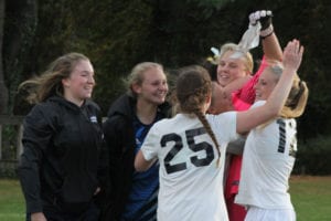 Northport teammates surround goalkeeper Emma Havrilla following the win. Photo by Desirée Keegan