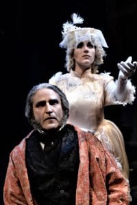 Jeffrey Sanzel as Scrooge & Jessica Contino as Ghost of Christmas Past in a scene from 'A Christmas Carol'. Photo by Brian Hoerger, Theatre Three Productions, Inc.