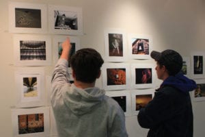 Photos in Suffolk County Community College’s new gallery are observed. Photo by Kevin Redding