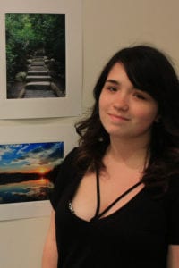 Centereach’s Sarah Mullen with her photo, top left, that was featured in the gallery. Photo by Kevin Redding