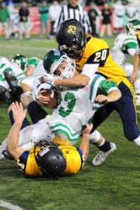Chris Sheehan and Kyle Boden tackle Seaford's star running back Danny Roell. Photo by Bill Landon