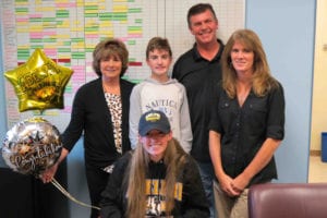 Jackie Brown is surrounded by her family as she signs her letter of intent to play field hockey for Adelphi University. Photo from Port Jefferson school district