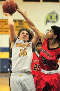 Comsewogue's Alan Smith shoots over a defender. Photo by Bill Landon