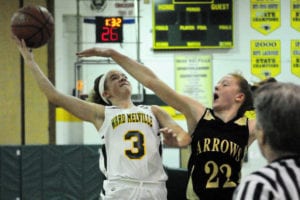 Julia Coletti moves the ball under the hoop in a game last season. File photo by Bill Landon